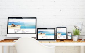 Desk with multiple devices on it. All devices have the same website up showcasing responsive web design.